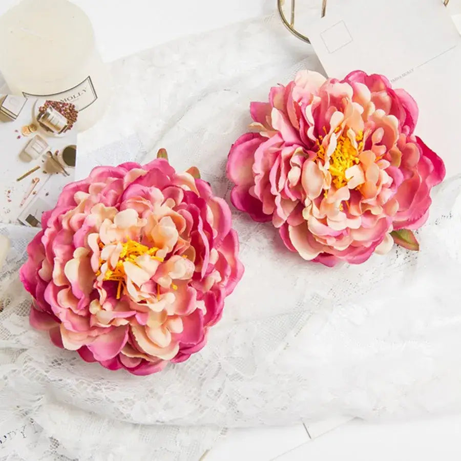 Two vibrant pink and peach gradient artificial flowers with yellow centers big peony headwear for wedding decoration