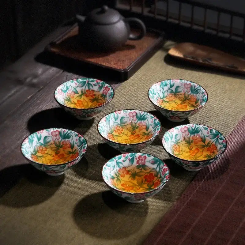 Six white porcelain hand-painted tea cups with vibrant pink, orange, and green floral patterns for decorbites blue dining set