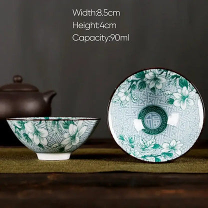 A delicate white porcelain hand-painted tea bowl with green floral pattern and geometric rim design for decorbites blue set