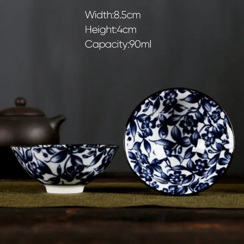 A delicate decorbites blue and white porcelain hand-painted tea bowl with intricate floral pattern and glossy finish