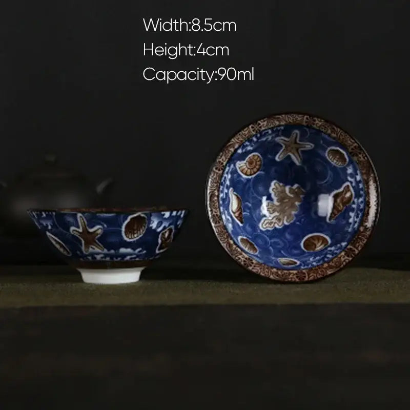 Blue ceramic bowl with brown seashell and starfish patterns and decorative rim in pink and black floral white porcelain hand-painted set decorbites blue