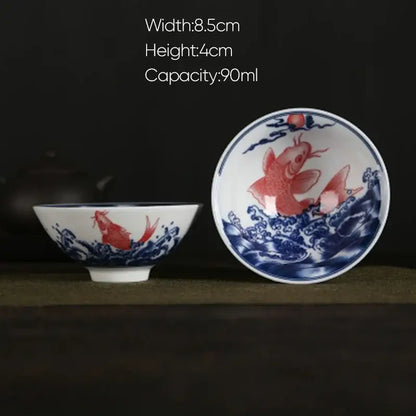 White porcelain hand-painted tea bowl with decorbites blue koi fish design in waves for dining room set