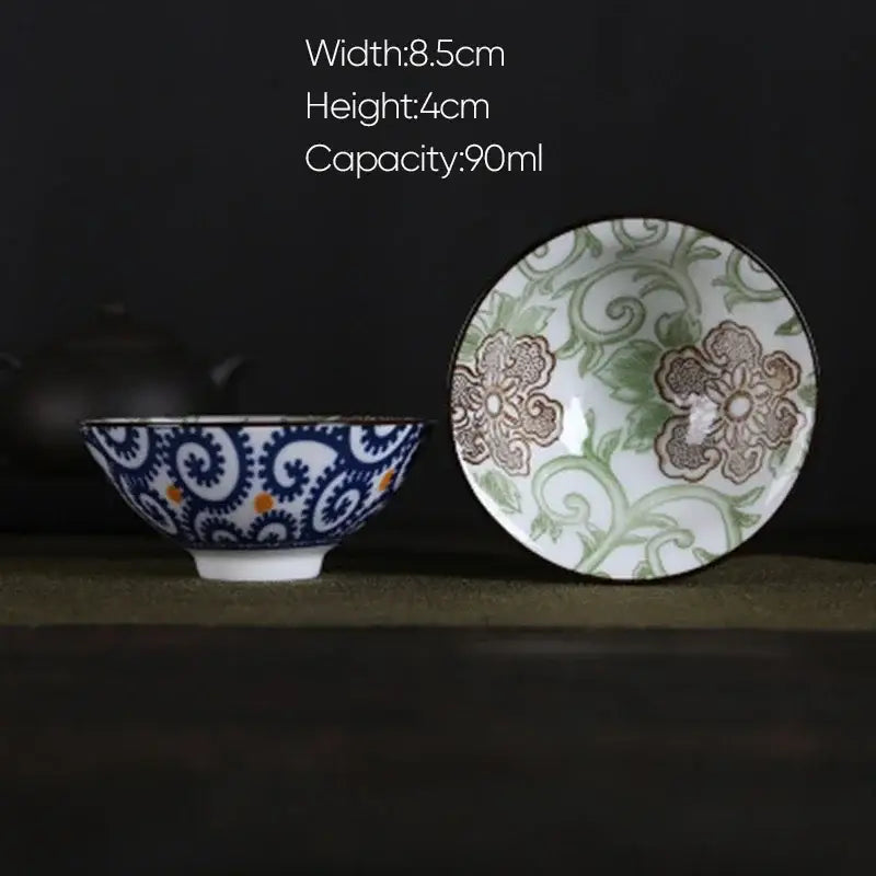 White porcelain hand-painted tea bowl with blue and orange swirls exterior and green floral interior decorbites blue