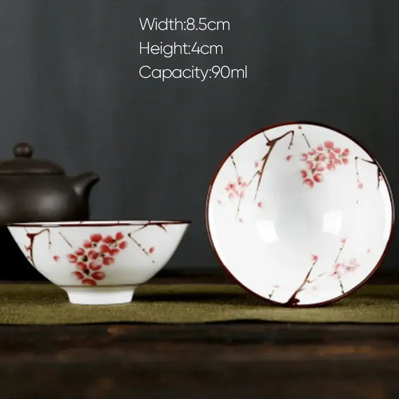 White porcelain hand-painted bowl with pink cherry blossom and black branches rimmed in dark brown for dining decorbites blue