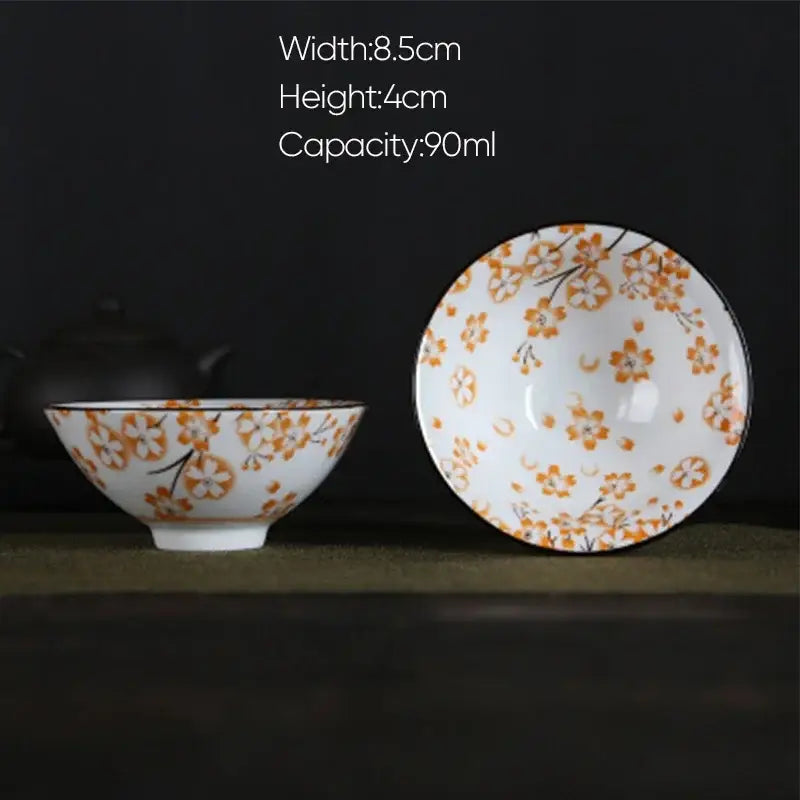 White porcelain hand-painted bowl with orange cherry blossoms and black branches from decorbites blue dining set