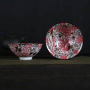 A pair of white porcelain hand-painted bowls with intricate pink and black floral patterns and glossy finish