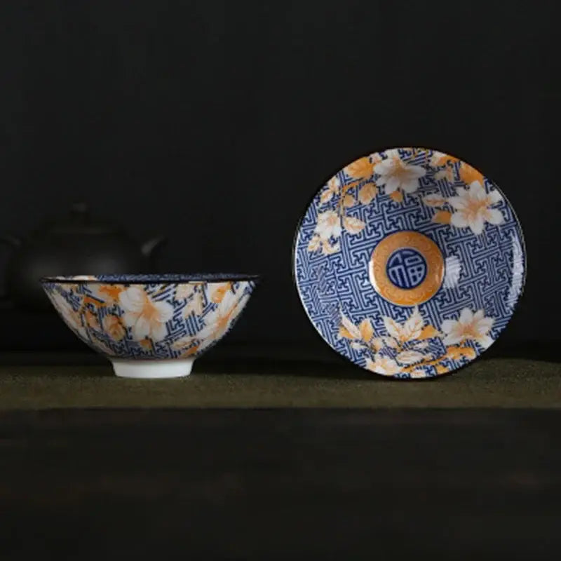 A decorbites blue and white porcelain hand-painted tea bowl with floral pattern and chinese characters on matching saucer