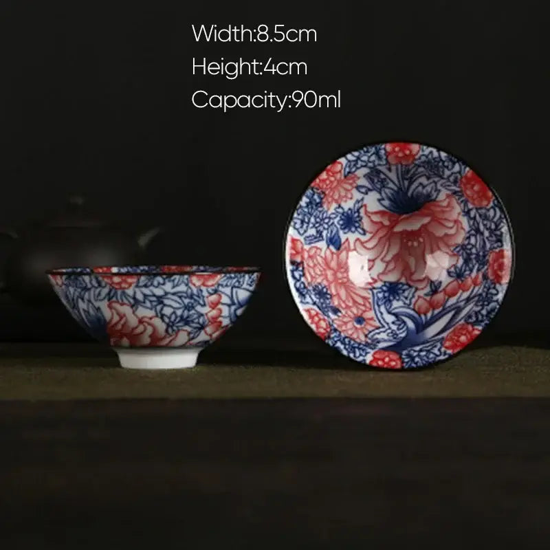 A delicate white porcelain hand-painted tea bowl with blue and red floral pattern and glossy glaze finish by decorbites blue