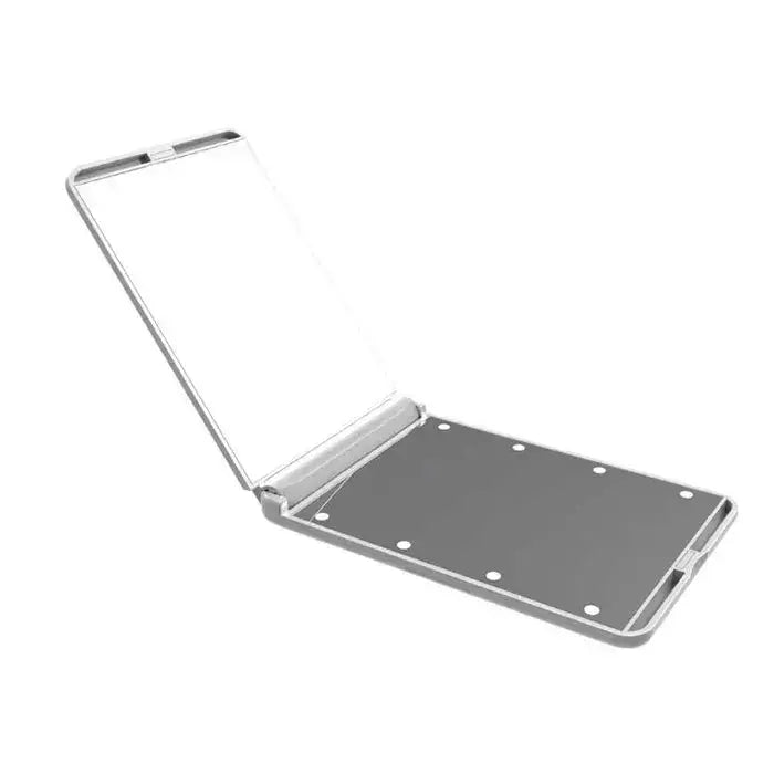Silver-framed vanity mirror compact with led vanity feature, matte gray back with six circular indentations for makeup use