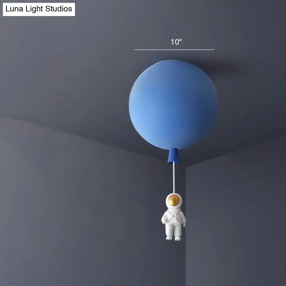 Blue balloon-shaped ceiling lamp with white astronaut figurine hanging below astronaut ceiling lamp for bedroom