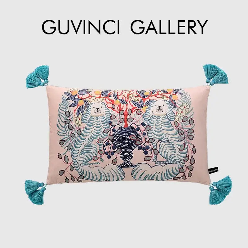 Pink rectangular lumbar pillow cover with embroidered white lion dog and blue lion vase design with teal tassels