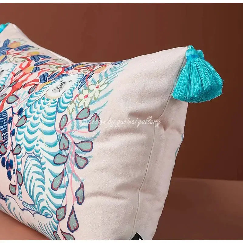 Cream-colored pink and blue lion dog lumbar pillow cover with vibrant stylized animals and turquoise tassel for bedroom decor