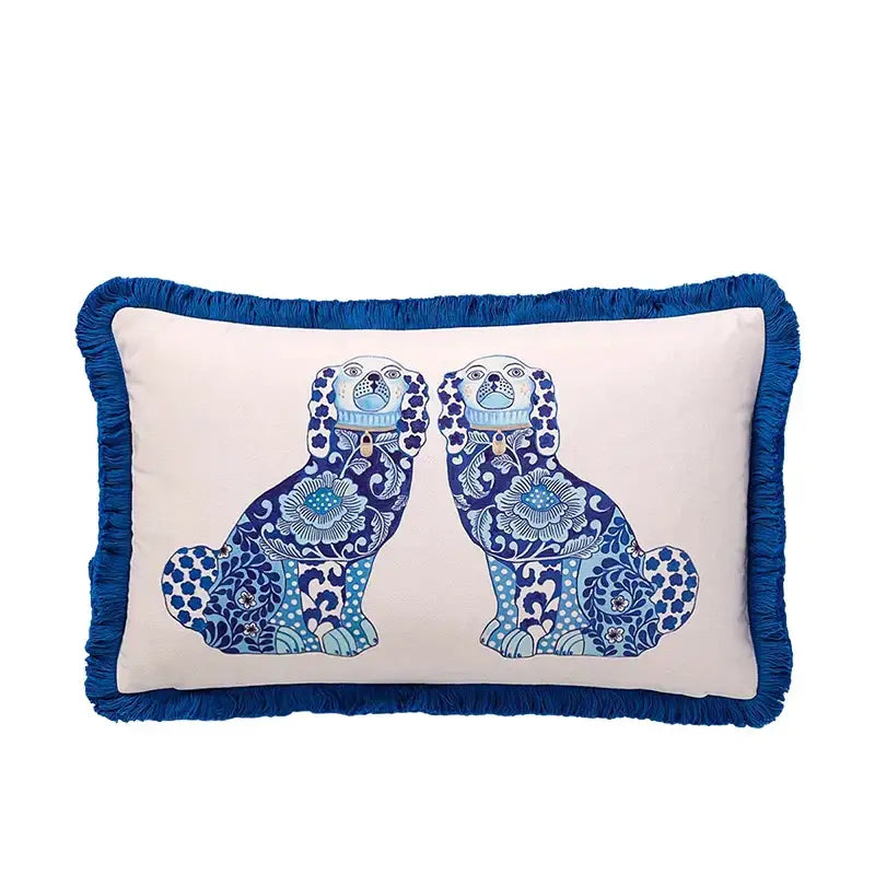 Cream-colored rectangular lumbar pillow cover with blue fringed edges and embroidered blue lion dog design for bedroom decor