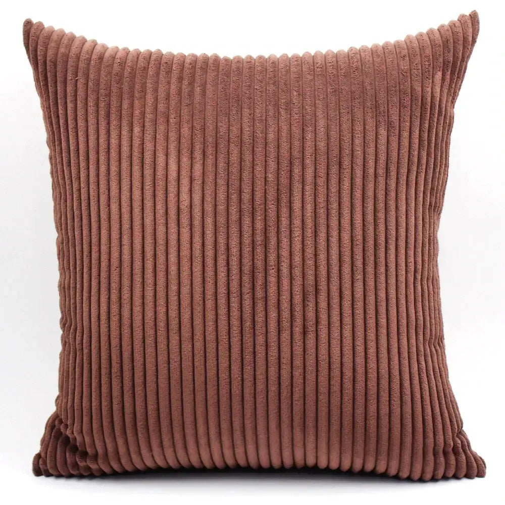 A square rust-colored decorbites corduroy pillow with textured vertical ribbed pattern for living room decor