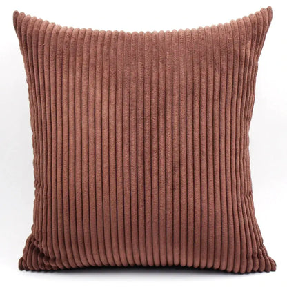 A square rust-colored decorbites corduroy pillow with textured vertical ribbed pattern for living room decor