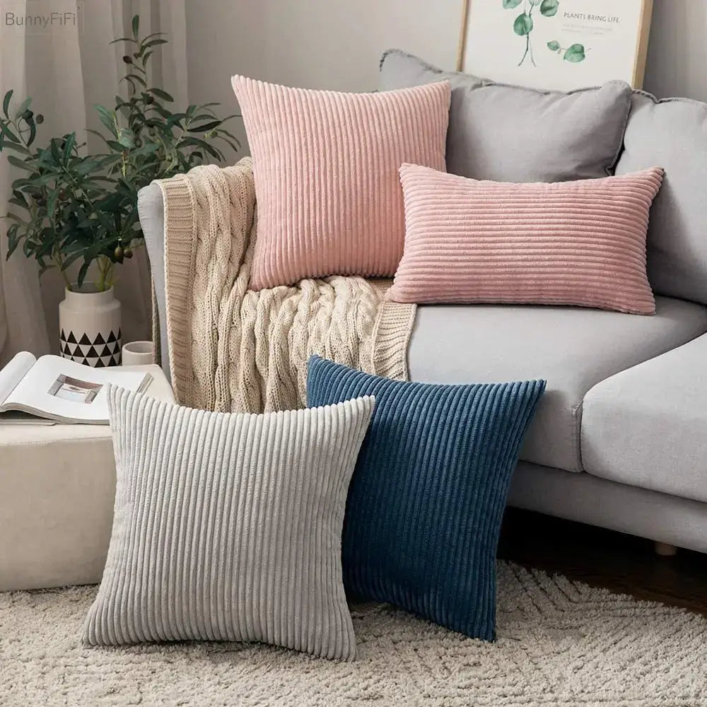 Pink and blue striped corduroy pillow cover with ribbed texture displayed on a cozy sofa by decorbites corduroy pillow
