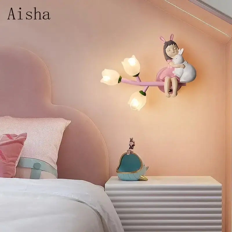 Pastel pink wall lamp with a whimsical girl and bunny figurine holding a white rabbit and three tulip led lights for kids room decorbites