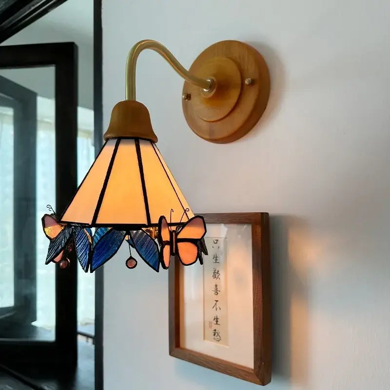 Pink butterfly glass led wall sconce with amber conical shade brass arm wooden base decorbites glass led decorbites wall sconce