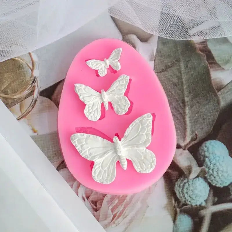 Pink butterfly silicone fondant mold with three white butterfly designs for cake decorating by decorbites