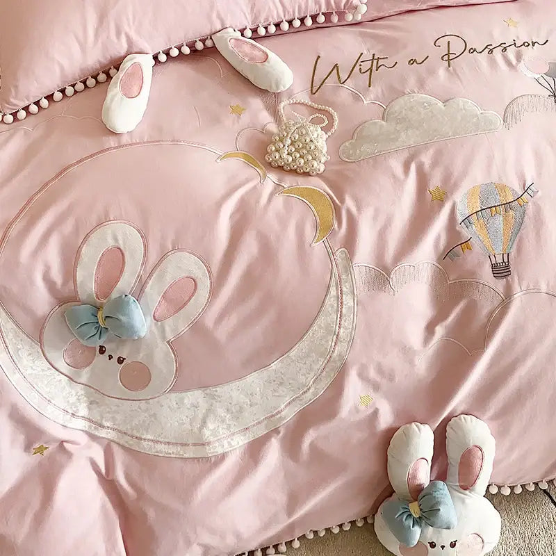 Pink cotton bedding set featuring a quilted decorbites cartoon rabbit moon design with lace trim and pearl details