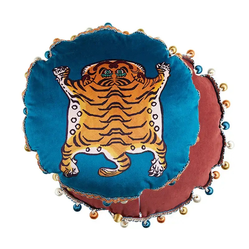 Plush circular deep teal velvet cushion with stylized orange tiger and pom-poms complements decorbites cat print velvet decor