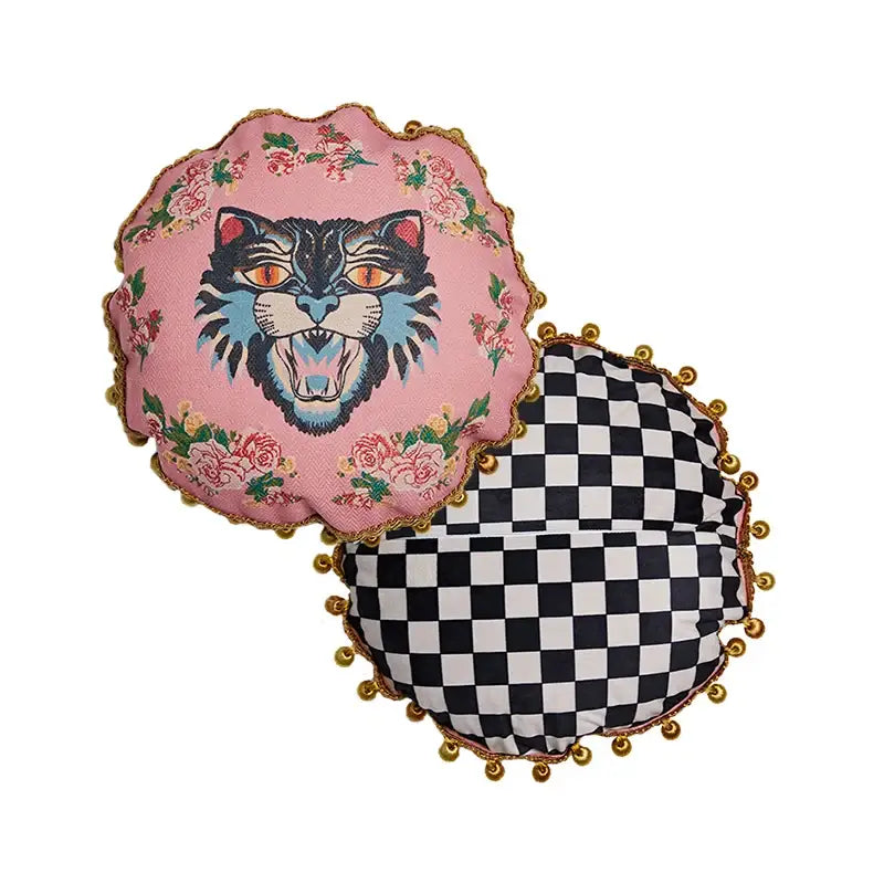 Pink cat print velvet throw pillow case featuring bold black and blue cat face with orange eyes and gold pom-pom tassels