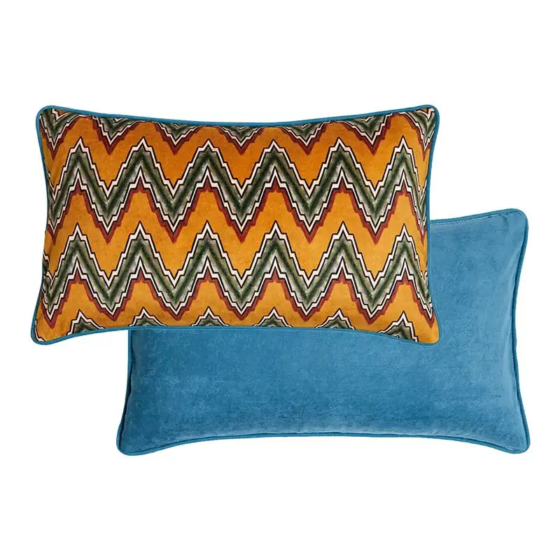 Vibrant zigzag patterned velvet pillow with teal border on blue cushion complementing decorbites cat print velvet throw