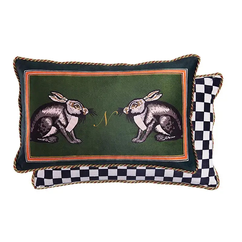 Dark green velvet rectangular pillow with embroidered rabbits and gold monogram framed by orange braided trim decorbites cat print velvet throw