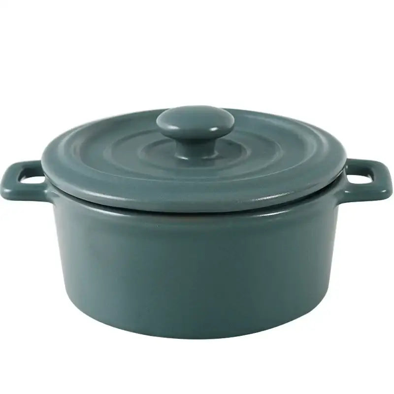 A sleek matte teal enameled cast iron dutch oven with lid and rounded handles for decorbites ceramic mini soup cookware