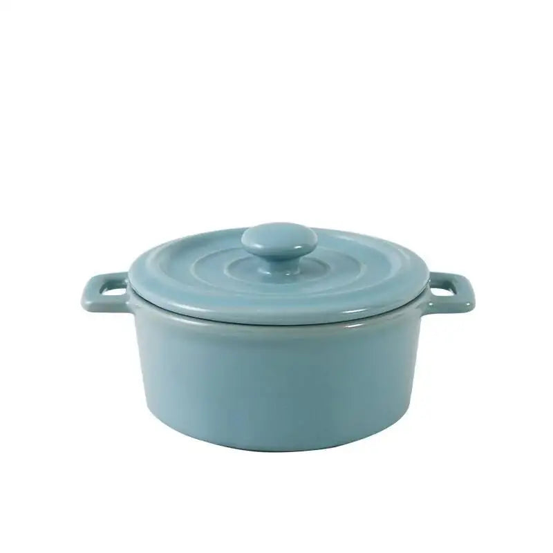 A sleek light blue enameled cast iron dutch oven with lid and handles for decorbites ceramic mini soup cookware