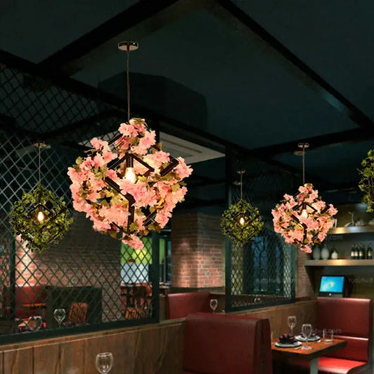 Pink cherry blossoms pendant light with green plants decorbites featuring a black metal frame for dining room use