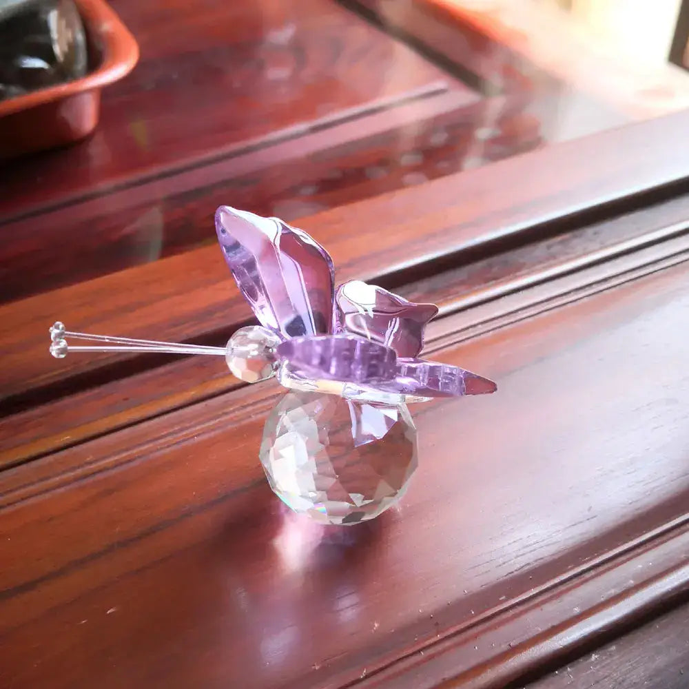 Delicate pink and clear crystal butterfly figurine with faceted wings on a multifaceted base for bedroom decor