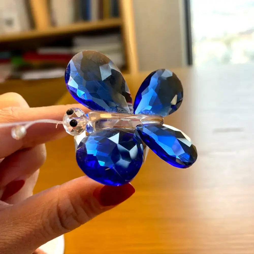 A sparkling blue crystal butterfly figurine with faceted wings and clear glass body for bedroom decorbites decor