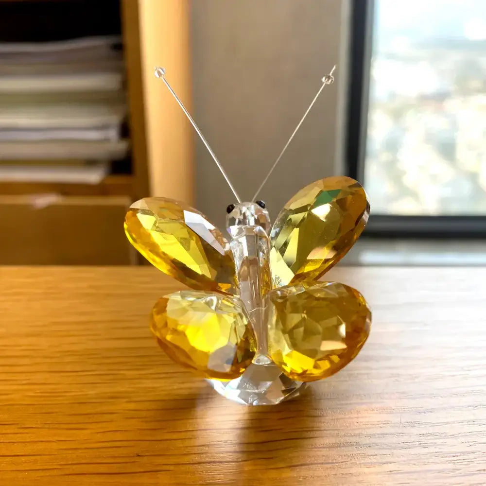 A sparkling yellow crystal butterfly figurine with clear glass antennae by decorbites for elegant bedroom decor