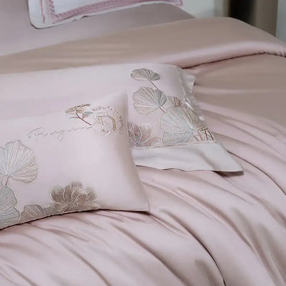 Pink satin pillowcases with silver-threaded ginkgo leaf embroidery and subtle monogram from decorbites cotton flowers bedding set