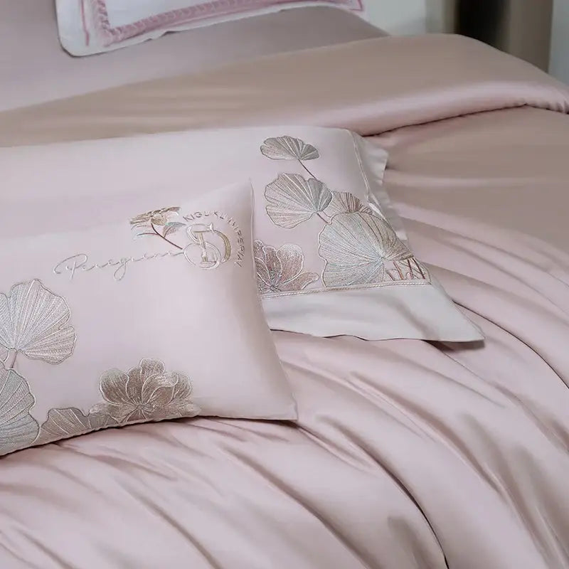 Pink satin pillowcases with silver-threaded ginkgo leaf embroidery and subtle monogram from decorbites cotton flowers bedding set
