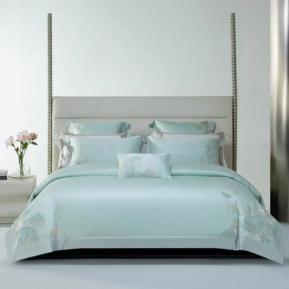 A soft mint green satin bedding set with delicate decorbites cotton flowers embroidery and matching pillow ensemble