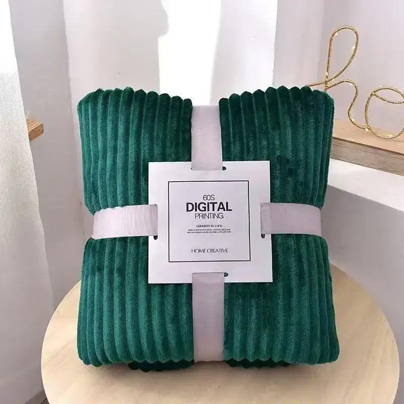 Deep green corduroy throw blanket with plush ribbed texture wrapped in white ribbon for cozy striped flannel fleece decorbites