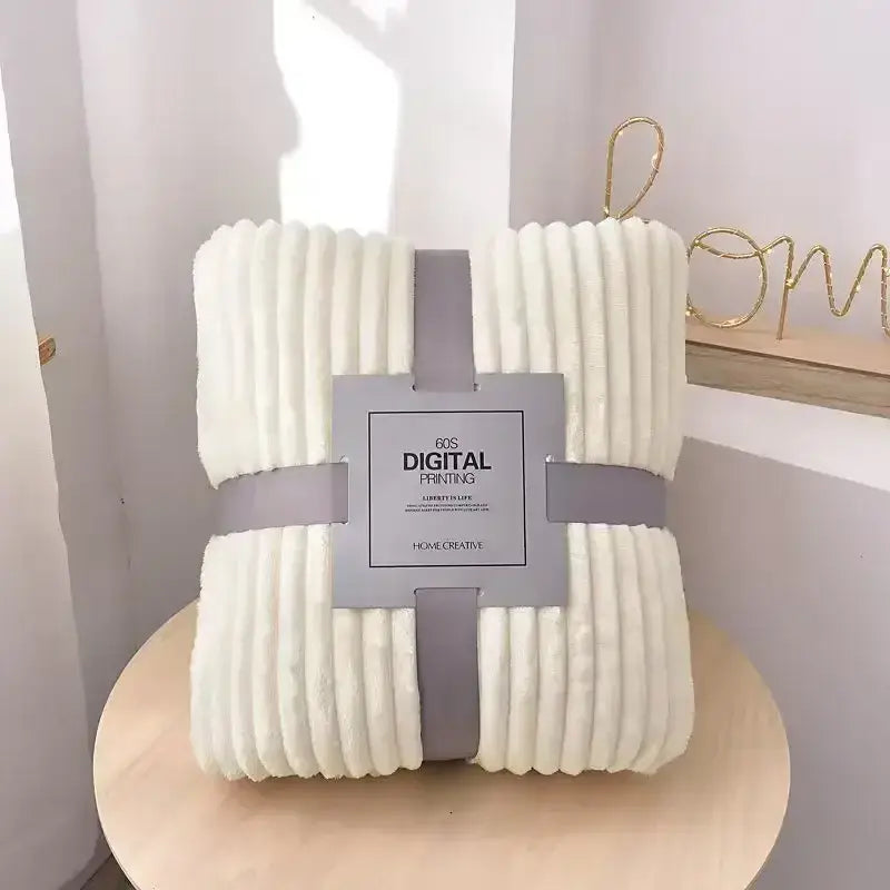 An off-white corduroy throw blanket with ribbed texture wrapped in gray ribbon for decorbites cozy striped flannel fleece decor