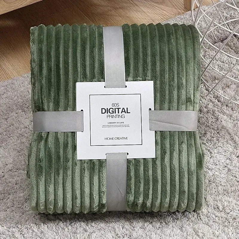 A plush olive green corduroy throw blanket with soft texture and folded edges shown alongside decorbites cozy striped fleece