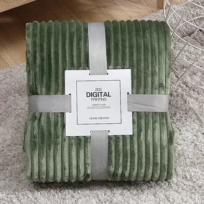 A plush olive green corduroy throw blanket with soft texture and folded edges shown alongside decorbites cozy striped fleece
