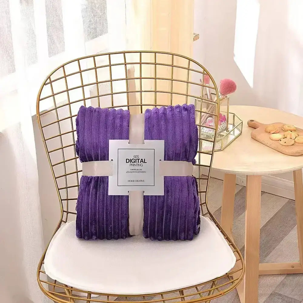 Purple corduroy throw blanket wrapped on wire chair showcasing decorbites cozy striped flannel fleece bedroom throw