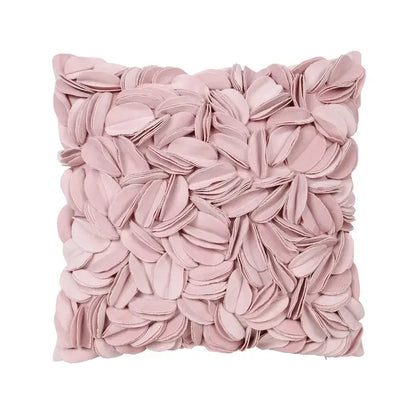 A soft blush pink plush pillowcase with a textured three-dimensional daisy sunflower floral design for decorbites