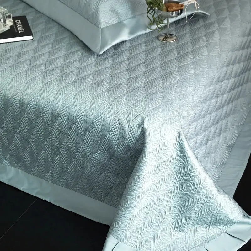 Light blue quilted bedspread set with subtle feather pattern made of decorbites cool lyocell fiber for bedroom use