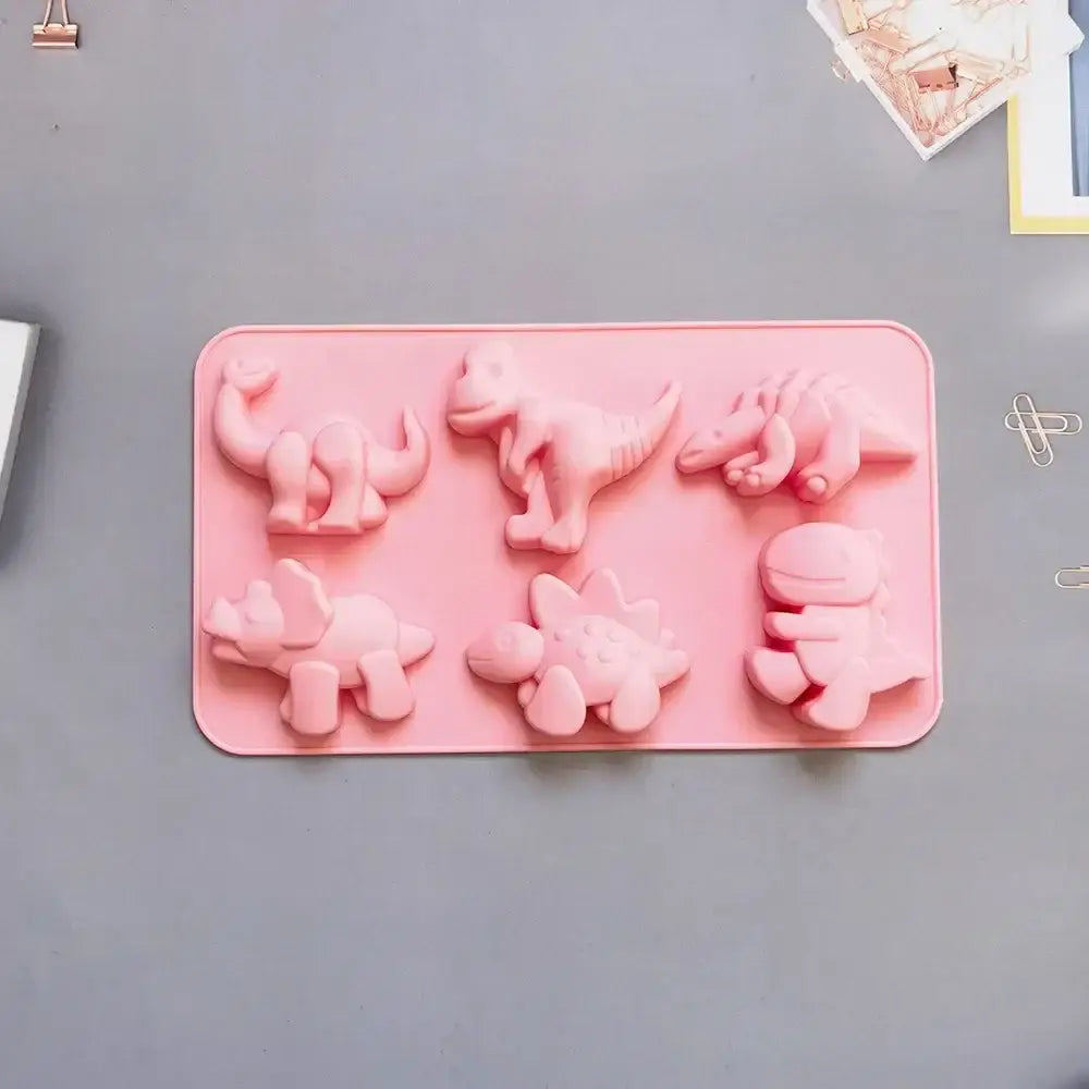 Pink dino silicone cake mold featuring six distinct prehistoric creature shapes for kitchen baking use