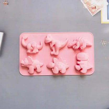 Pink dino silicone cake mold featuring six distinct prehistoric creature shapes for kitchen baking use
