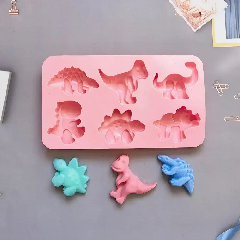 Pink dino silicone cake mold made of silicone with six distinct prehistoric creature shapes for kitchen baking use