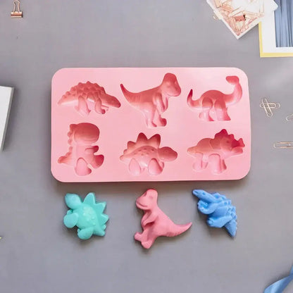 Pink dino silicone cake mold made of silicone with six distinct prehistoric creature shapes for kitchen baking use