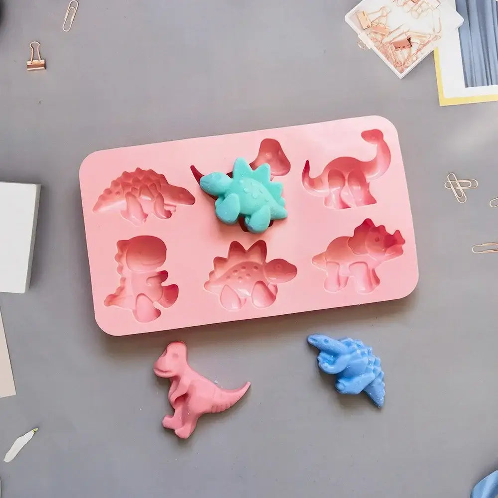 Pink dino silicone cake mold with teal and blue molded dinosaurs for kitchen baking silicone cake mold tray