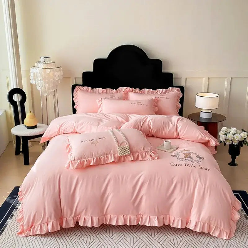 Pink embroidered bear cotton bed skirt set featuring ruffled detailing and cute little bear design for bedroom use